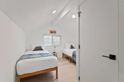 Bright twin bedroom with vaulted ceilings and clean, modern style