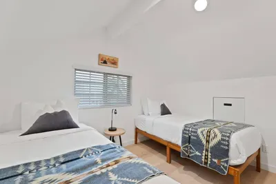 Bright loft bedroom with two twin beds and cozy Southwestern-style accents