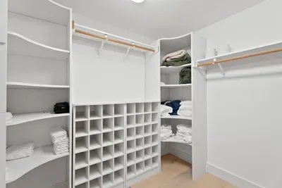 Spacious walk-in closet with custom shelving and abundant storage