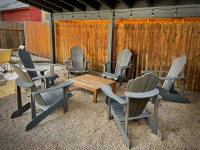 Cozy covered patio with Adirondack seating and string lights