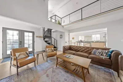 Bright loft-style living room with soaring ceilings and stylish seating
