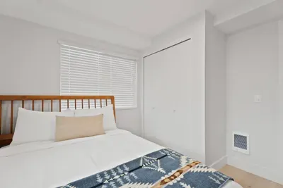 Bright, cozy bedroom with natural light and built-in closet storage