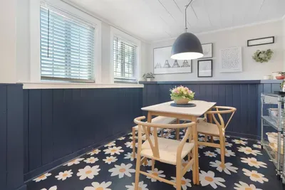Bright, stylish dining nook with natural light and bold designer touches