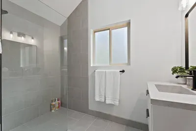 Bright modern bathroom with walk-in glass shower and sleek finishes
