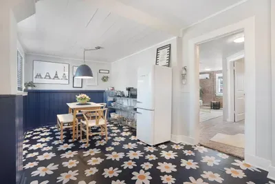 Charming dining nook with bold floral floors and retro-style touches
