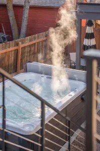 Private, steaming hot tub in fenced yard with covered patio seating