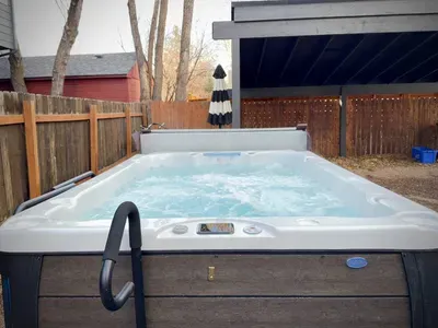 Private backyard hot tub for relaxing soaks under the covered patio