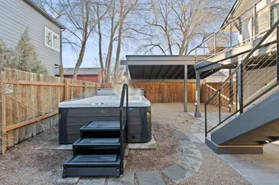 Fenced yard oasis with hot tub, upper deck seating & carport