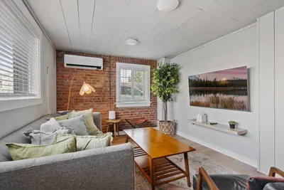 Cozy modern living room with exposed brick and a bright, stylish feel