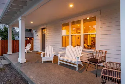 Inviting covered front porch with cozy seating and warm evening ambiance