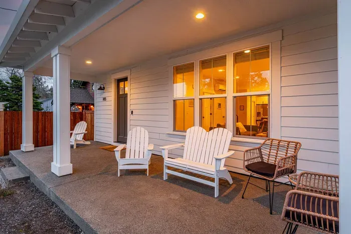 Inviting covered front porch with cozy seating and warm evening ambiance