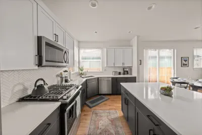 Bright modern kitchen with large island and stylish two-tone cabinetry