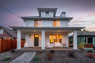Welcoming home with covered porch, rocking chairs, and warm sunset glow