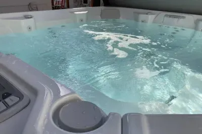 Relax and recharge in the spacious private hot tub with soothing jets
