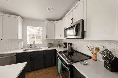 Bright modern kitchen with stainless appliances and stylish finishes