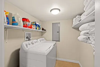 Convenient laundry room with stocked supplies and fresh towel storage