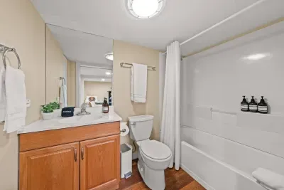 Bright full bathroom with tub-shower combo and spacious vanity