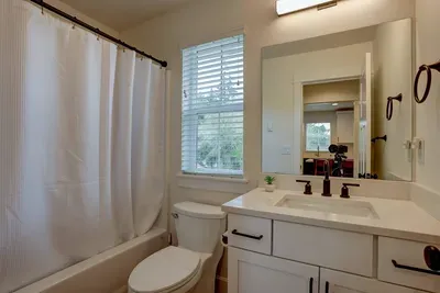 Bright modern bath with tub/shower, quartz vanity & natural light