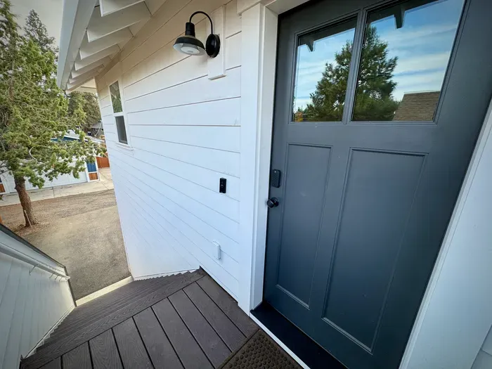 Private, well-lit entry with smart lock and modern farmhouse style.
