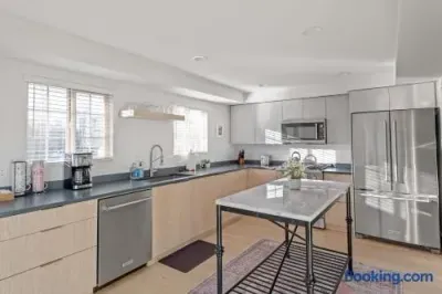 Bright modern kitchen with island, stainless appliances, and great natural light