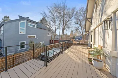 Sunny elevated deck with modern railing and inviting outdoor seating