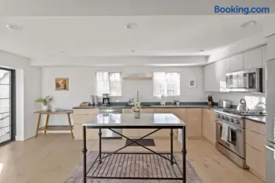 Bright modern kitchen with island, stainless appliances, and natural light