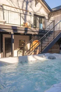 Private bubbling hot tub with modern balcony and sunny outdoor charm