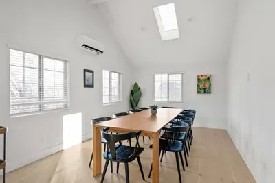 Bright vaulted dining room with skylight and seating for the whole group