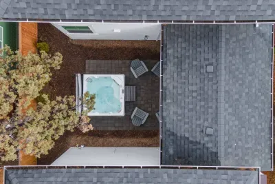 Private backyard hot tub patio with Adirondack seating