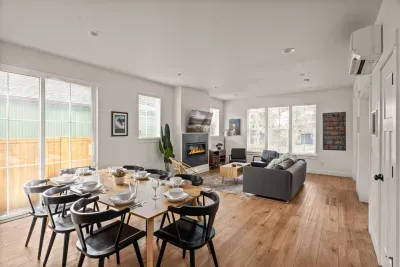 Bright open living space with fireplace, dining for 6, and natural light