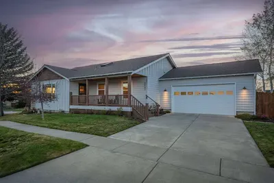 Inviting single-level home with porch, garage, and sunset curb appeal