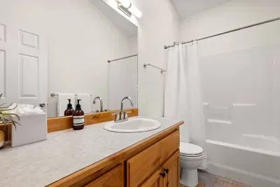 Bright full bathroom with spacious vanity and tub-shower combo