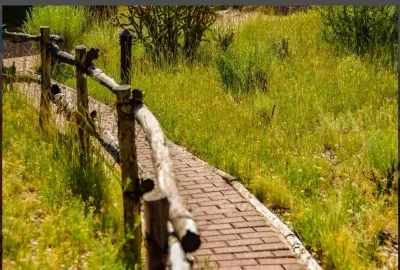 The terrain compliments the Santa Fe environment with coyote fences and wildlife.