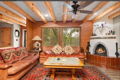 Stunning southwestern living area with a wood burning kiva provides plently of lounging space.