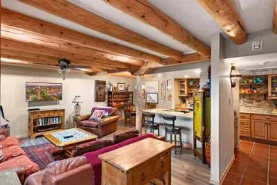 A full vista of the ground floor living space with a kitchen, half bath, living space, dining room and beautiful kiva.