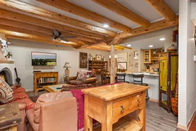 A full vista of the ground floor living space with a kitchen, half bath, living space, dining room and beautiful kiva.