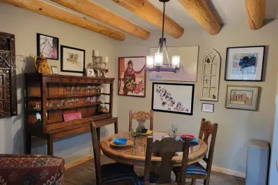 This stunning dining area also serves as an art gallery. The 18th Century hutch makes access to glassware super easy!