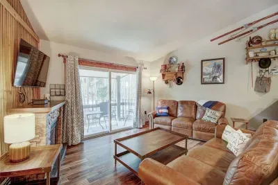 Large gathering space with antique hutch, electric fireplace, Smart TV with cable, two amazing leather sofas- one with a queen bed, the other has two recliners for relaxing after a day in the mountains. Opens to a balcony with gas grill.