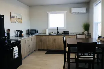 Full kitchen with modern appliances, dining table, and climate control for comfortable extended stays.