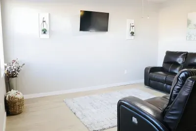 Bright living room with comfortable seating and wall-mounted TV for relaxing.