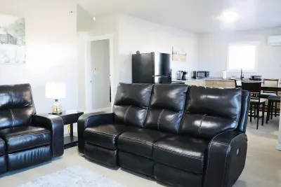 Sink into ultimate comfort on these spacious black leather recliners. The open living space flows into full kitchen and dining area for easy daily living.
