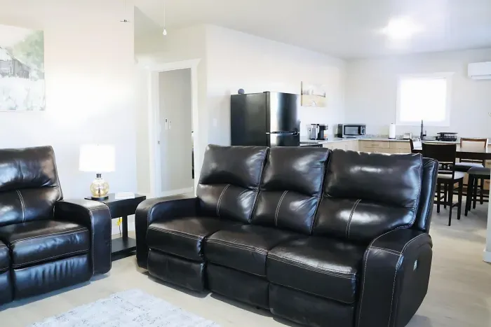 Sink into ultimate comfort on these spacious black leather recliners. The open living space flows into full kitchen and dining area for easy daily living.