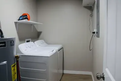 Full-size washer and dryer with shelf and extra space.