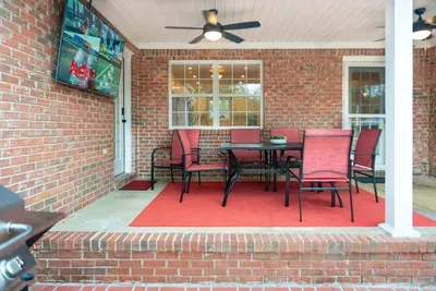 Patio with TV, dining area and additional seating