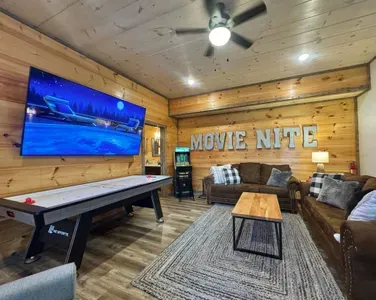 Lower level movie room, game room, attached bunkroom and walkout to hot tub with TV