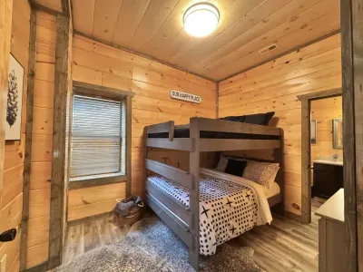 Lower level bunkroom with 2 queen beds, next to movie/gameroom and walkout hot tub - attached large bathroom with bathtub and single sink