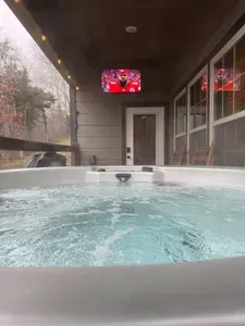 Lower level outdoor 6 person hot tub with outdoor TV