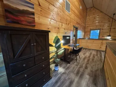 Loft outside of master bedroom that has desk with monitor