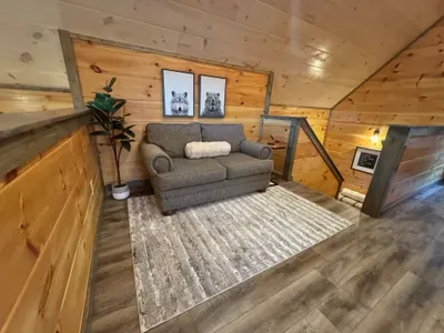 Loft outside of master bedroom that has desk with monitor