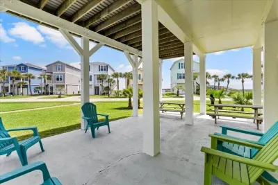 Relax in the shade after a day at the beach - this outdoor living space is a favorite for reading, lounging, and chatting. 